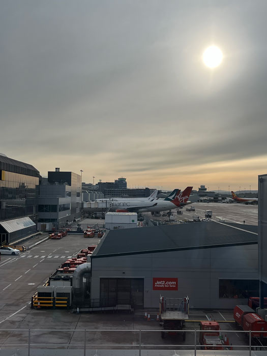 View from Aspire Lounge Terminal 2 across Manchester Airport pier toward Terminal 1