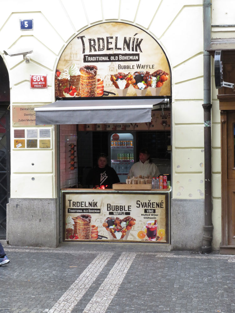 A stall at the side of the square selling Trdelník (Chimney Cake)